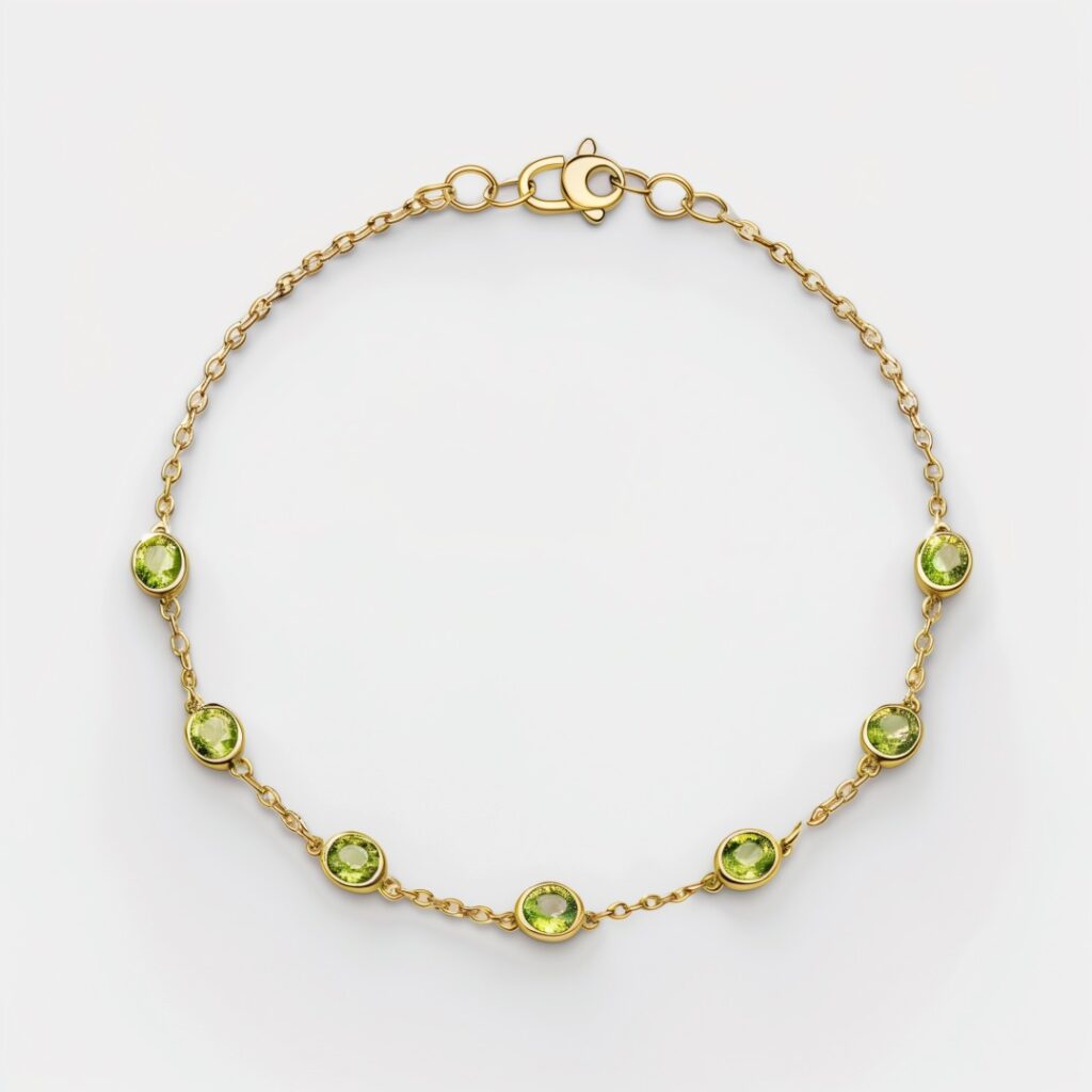 Gold chain bracelet with five peridot solitaire pendants.