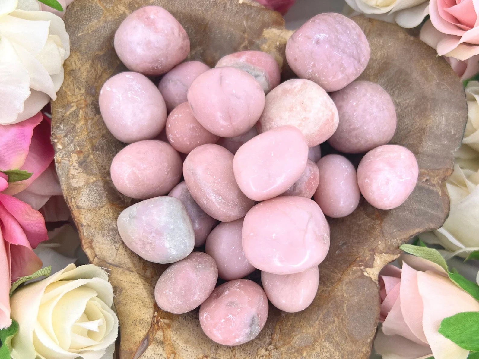 Pink Opal Meaning & Properties: use these tumbled stones to invite the energy of pink opal - place the stones in your living space or by holding one while meditating.